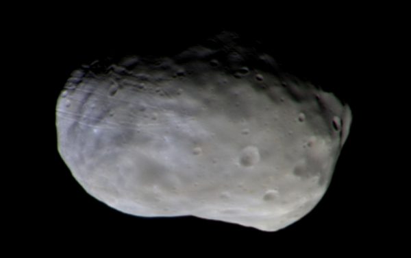 Colour composite of Phobos taken with CaSSIS on 26 November 2016. The observation was made at 87 m/px from a distance of 7700 km. It is composed of several framelets that have been “stitched” together. Two of the colour filters used for CaSSIS are actually outside the wavelength response of the human eye. Hence, this is not a “true” colour image. However, showing the data as a colour representation can tell us whether the surface is redder or bluer, which can in turn tell us about the surface mineralogy (Credit: ESA/Roscosmos/CaSSIS)